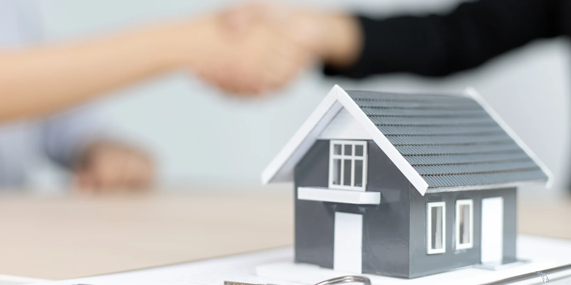 Real estate agent and homebuyers discussing commission changes in a modern South Florida home, highlighting new 2025 rules in Boca Raton and Fort Lauderdale